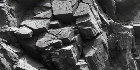 Closeup of textured cracked rocky stone surface in grayscale