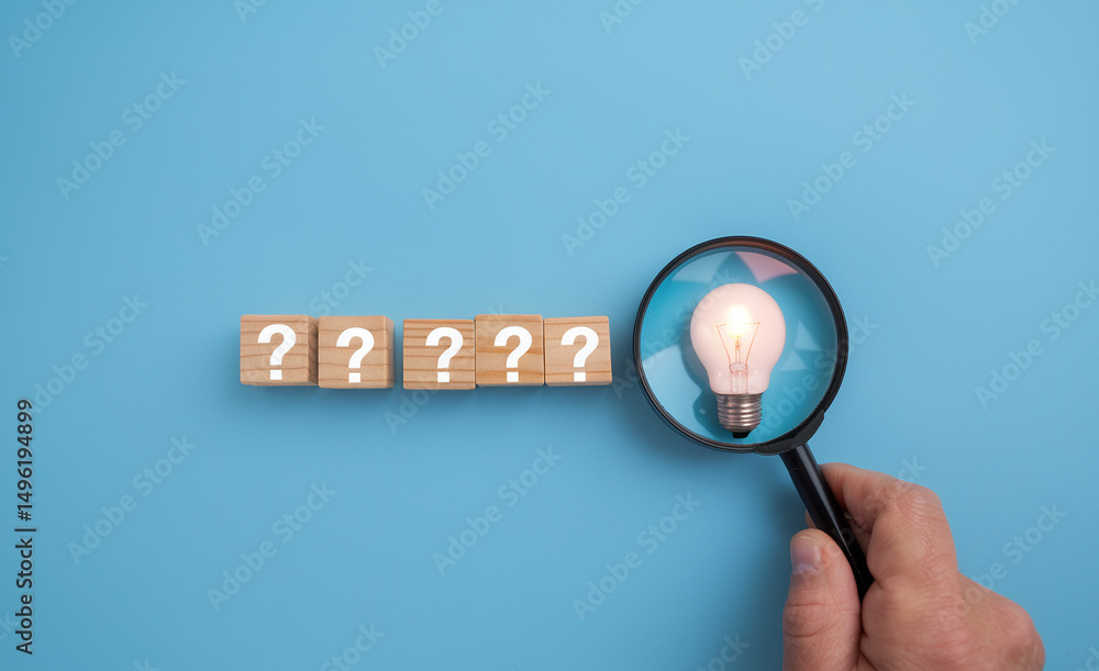 Poster Question marks on blocks with light bulb under magnifying glass on blue background concept idea