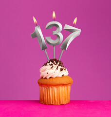 Birthday card on violet background - Candle number 137