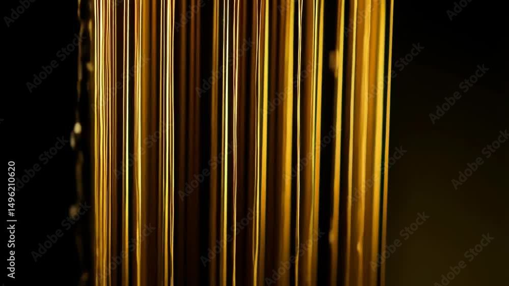 Poster abstract golden strands hanging with depth of field on black backdrop for luxury concept background 