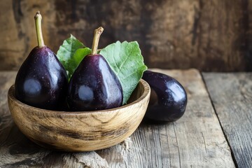 Fresh figs in a wooden bowl on table
