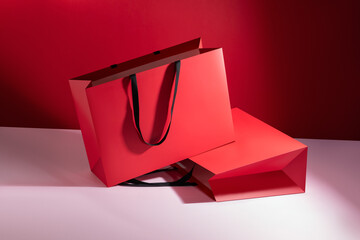 Red paper glossy shopping bag mockup with black handles