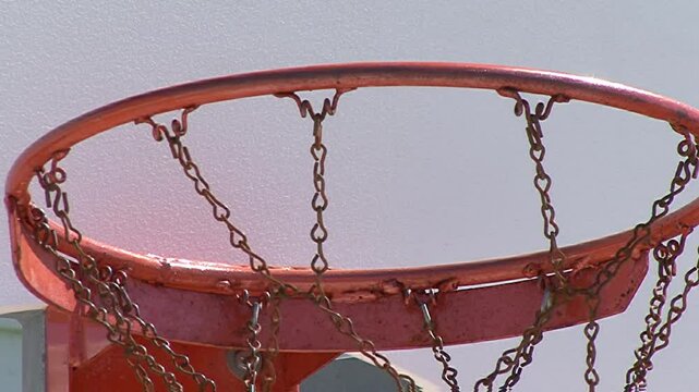 Orange Basketball Basket with a Ball that has Been Dunked Several Times