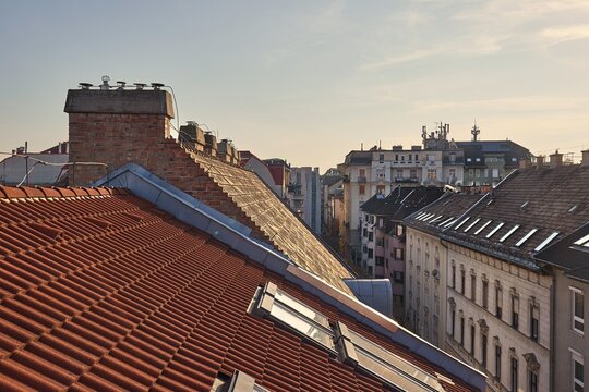 Tiled Building Roofs Over a City Street