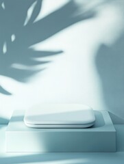 Minimalist wireless stylus charger on pale glacier blue plinth with soft pastel background