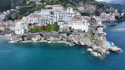 Selbstklebende Fototapeten Grün Blau Amalfi Coast At Amalfi In Salerno Italy. Coastal City. Waterfront Landscape. Amalfi Coast At Salerno Italy. Beach Scenery. Medieval Buildings. Amalfi Coast Skyline. Beach Landscape.  © bydronevideos