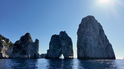 Faraglioni Rocks At Capri In Naples Italy. Beach Landscape. Tourism Landmark. Faraglioni Rocks At Capri In Naples Italy. Bay Of Naples Skyline. Geological Formation. Paradisiac Capri Island.