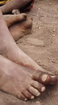 Dirty feet of African children from Tanzania. Maasai people.