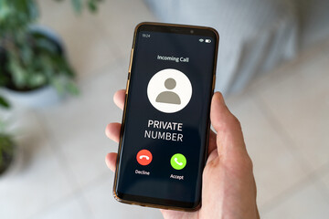 Receiving incoming call from a private number. Concept of danger and privacy.