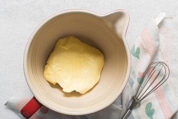 Overhead view of organic butter in a mixing bowl with handle, natural butter from grass fed cows
