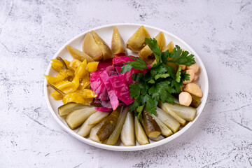 A vibrant array of pickled vegetables showcases the rich flavors of Eastern European cuisine. The dish features colorful beet, tangy pickles, and fresh herbs, inviting culinary exploration