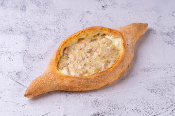 A beautifully crafted traditional dish arrives, featuring a unique shape, filled with savory...