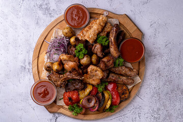 A beautifully arranged platter brimming with a variety of grilled meats, including chicken, beef,...