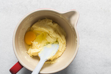 Creaming butter sugar and egg with a spatula, the process of making a cake and cookies, mixing butter and sugar to make a cake and cookies