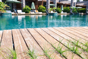 Outdoor swimming pool with wooden deck at resort
