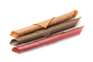 Delicious fruit leather rolls on white background, top view