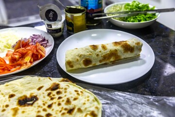 The most traditional and classic shawarma prepared in Syrian bread or pita bread grilled on a stone