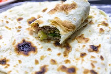 The most traditional and classic shawarma prepared in Syrian bread or pita bread grilled on a stone
