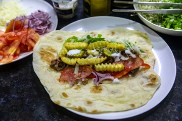 The most traditional and classic shawarma prepared in Syrian bread or pita bread grilled on a stone