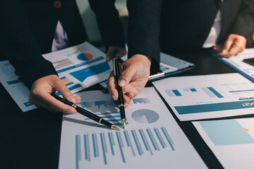 Teamwork with business people analysis cost graph on desk at meeting room. double exposure...