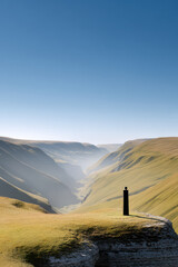 aerial view of majestic cliffs with solitary sculpture standing proudly against backdrop of nature