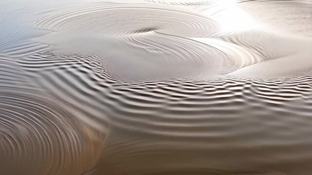 Aerial view of fluid sand ripples creating abstract circular patterns on a vast sunlit surface, organic texture in natural shades