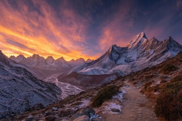 Fototapeta premium Vibrant Sunset Over Snow Covered Mountain Range