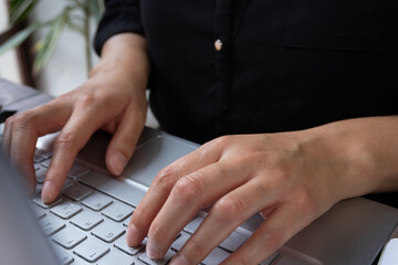 Woman's hands working on her computer keyboard