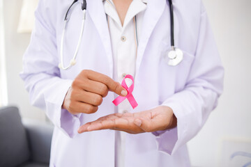 Doctor Hands Holding Pink Cancer Awareness Ribbon