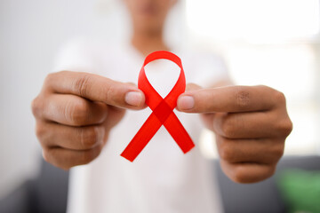 Hand Holding Red Ribbon for December World Aids Day