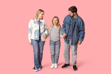 Fototapeta premium Happy family in stylish denim clothes on pink background