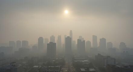 Fototapeta premium Hazy Urban Landscape with Sun Above Buildings