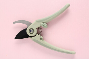 Gardening grey secateurs on pink background