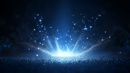 A digital image depicting a vibrant blue glitter explosion on a dark background.  Bright sparkles radiate outwards from a central point creating a dynamic effect.