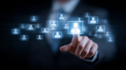 A man is pointing at a screen with a lot of people on it