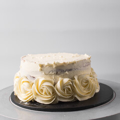 Piping rosettes on a cake using buttercream, Cake being covered in buttercream rosettes, cake being...