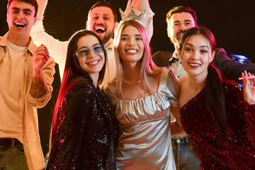 Group of young people at party in night club