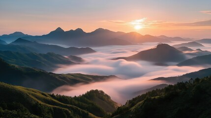 Golden sunrise illuminates rolling fog cascading over majestic mountain peaks, creating a breathtaking vista of nature's grandeur