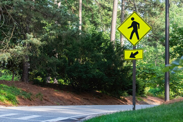 Pedestrian crossing sign in a park.