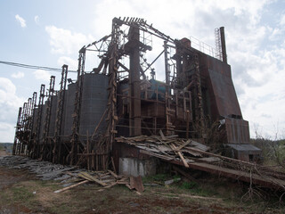 Abandoned Industrial Facility With Decaying Structures and Weathered Materials Observed in a Rural...