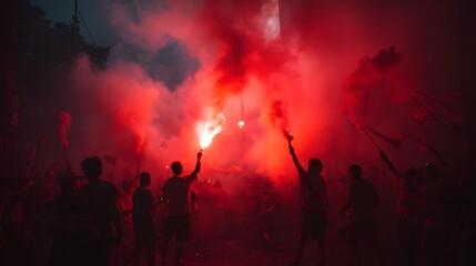 People holding flares in the air creating red smoke in a dark environment at an outdoor event scene