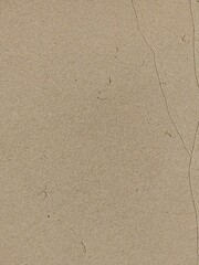 Close-up of a beige textured surface with subtle cracks.