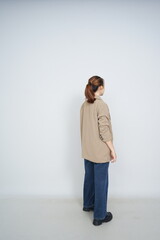 A collection of studio portraits featuring a stylish young woman posing in various confident stances against a clean white background.