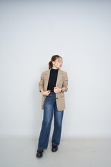 A collection of studio portraits featuring a stylish young woman posing in various confident stances against a clean white background.