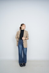 A collection of studio portraits featuring a stylish young woman posing in various confident stances against a clean white background.