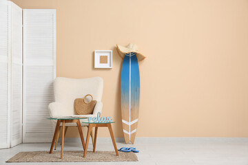 Interior of stylish living room with white armchair, coffee table and surfboard