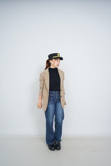 A collection of studio portraits featuring a stylish young woman posing in various confident stances against a clean white background.