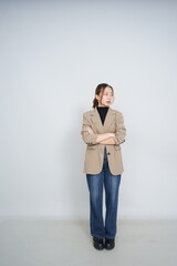A collection of studio portraits featuring a stylish young woman posing in various confident stances against a clean white background.