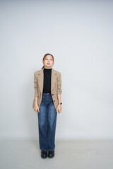 A collection of studio portraits featuring a stylish young woman posing in various confident stances against a clean white background.