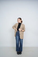 A collection of studio portraits featuring a stylish young woman posing in various confident stances against a clean white background.